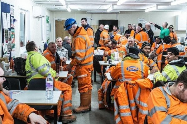 onstruction workers in the Scottish town of Forres await the start of their shift.