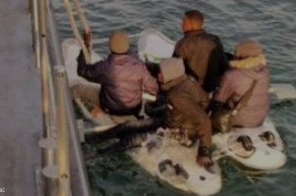 The four men used shovels as paddles after attaching two windsurfing boards togethe