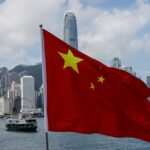 the chinese national flag is seen in front of the financial district central on the chinese national day in hong kong