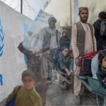 displaced afghans receive assistance as they