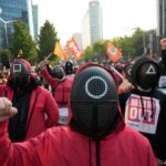 south korean workers wear 'squid game' costumes to protest government